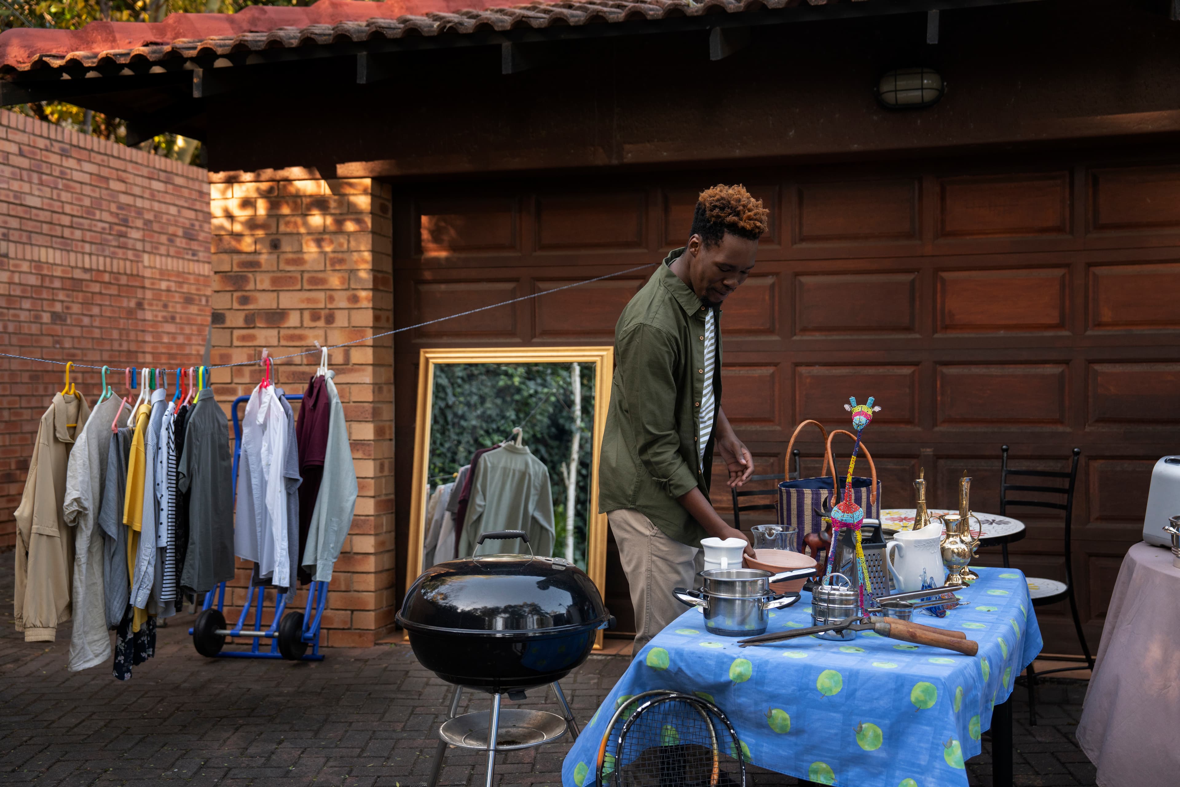 Seller behind a table of goods at a weekend sale